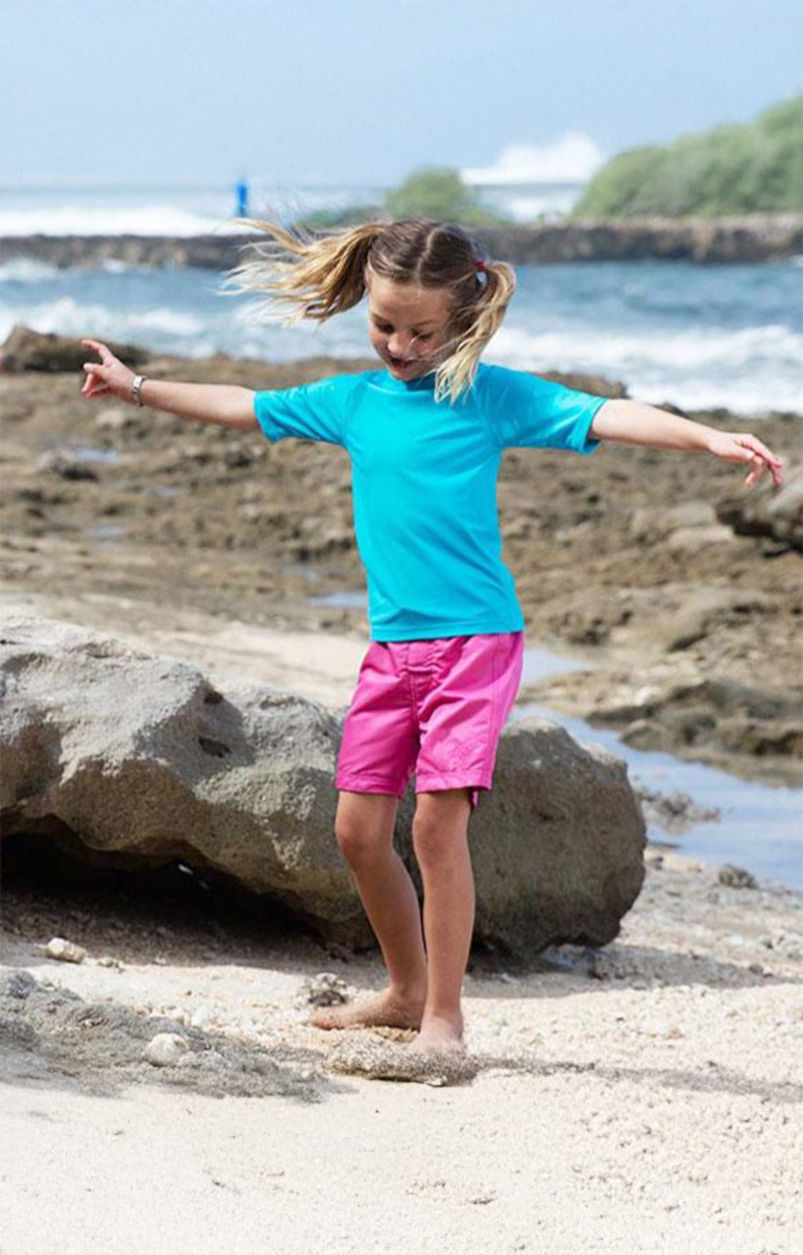 Little girl in the girl's board shorts in bubblegum|bubblegum