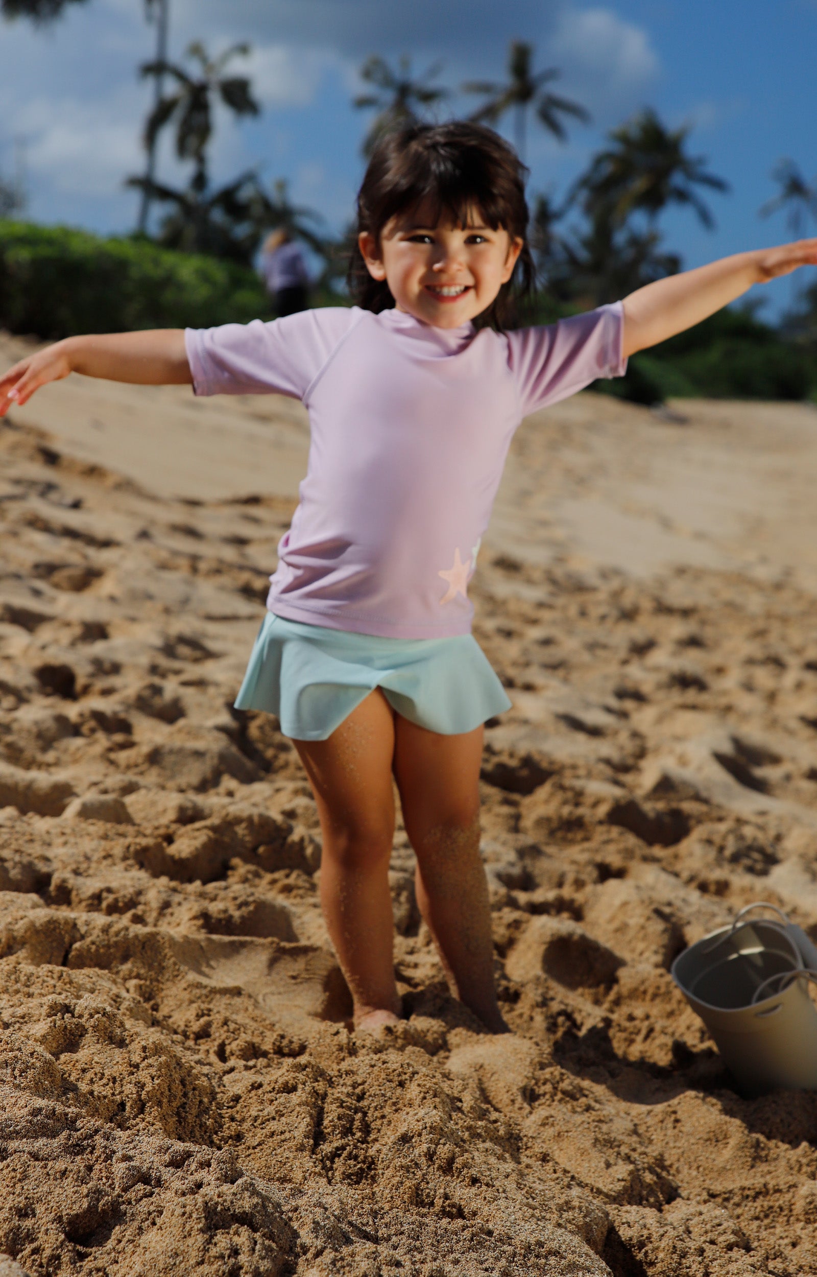 girl playing on the beach in dewdrop flounce skirt|dusty-pink