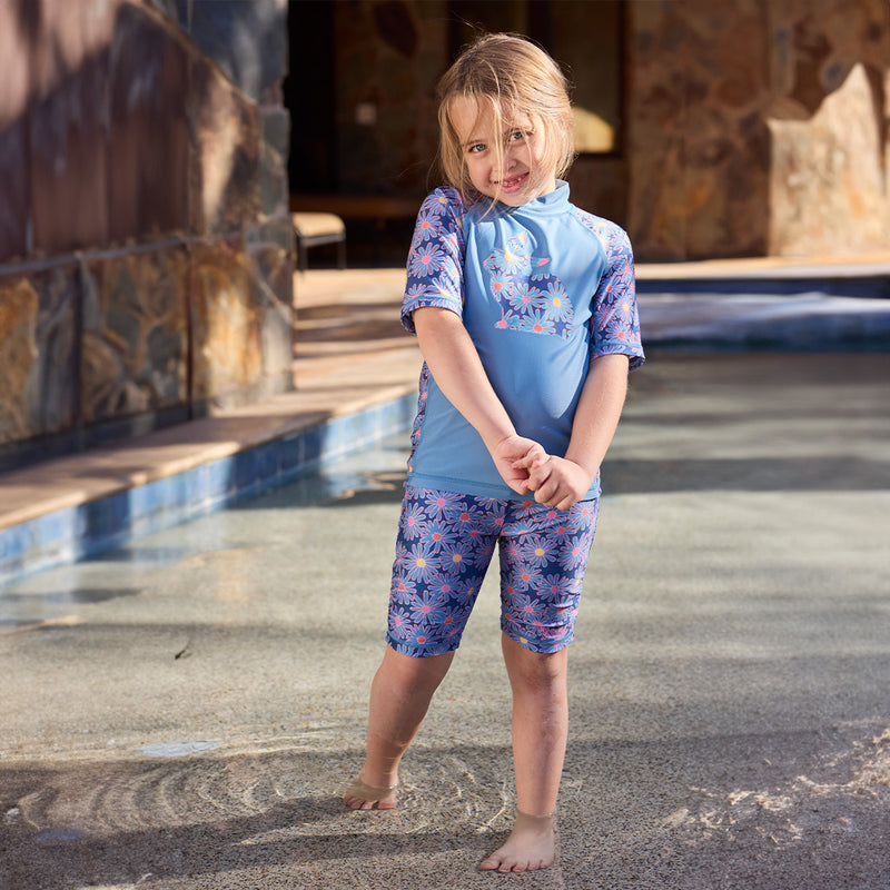 girl in short sleeve sunny swim shirt with feet in the pool|moonlight-daisies