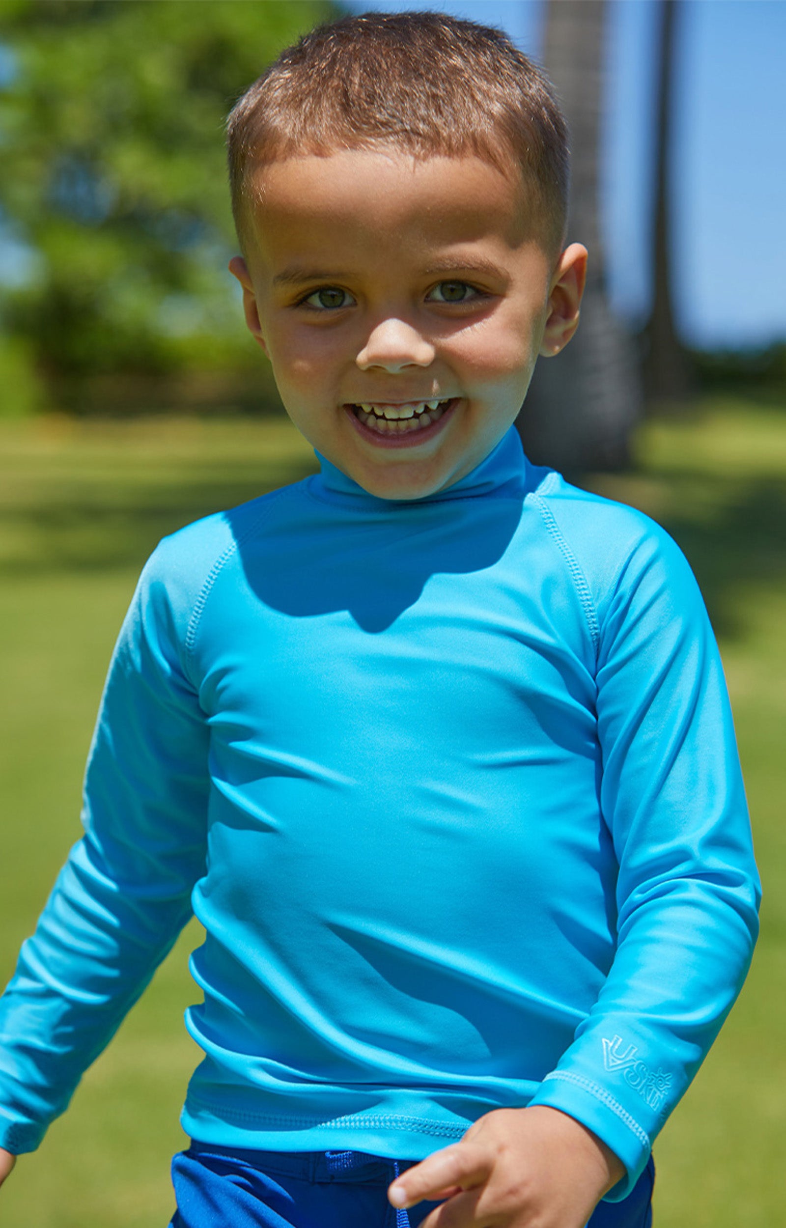 Little boy in the kid's long sleeve swim shirt in aqua|aqua