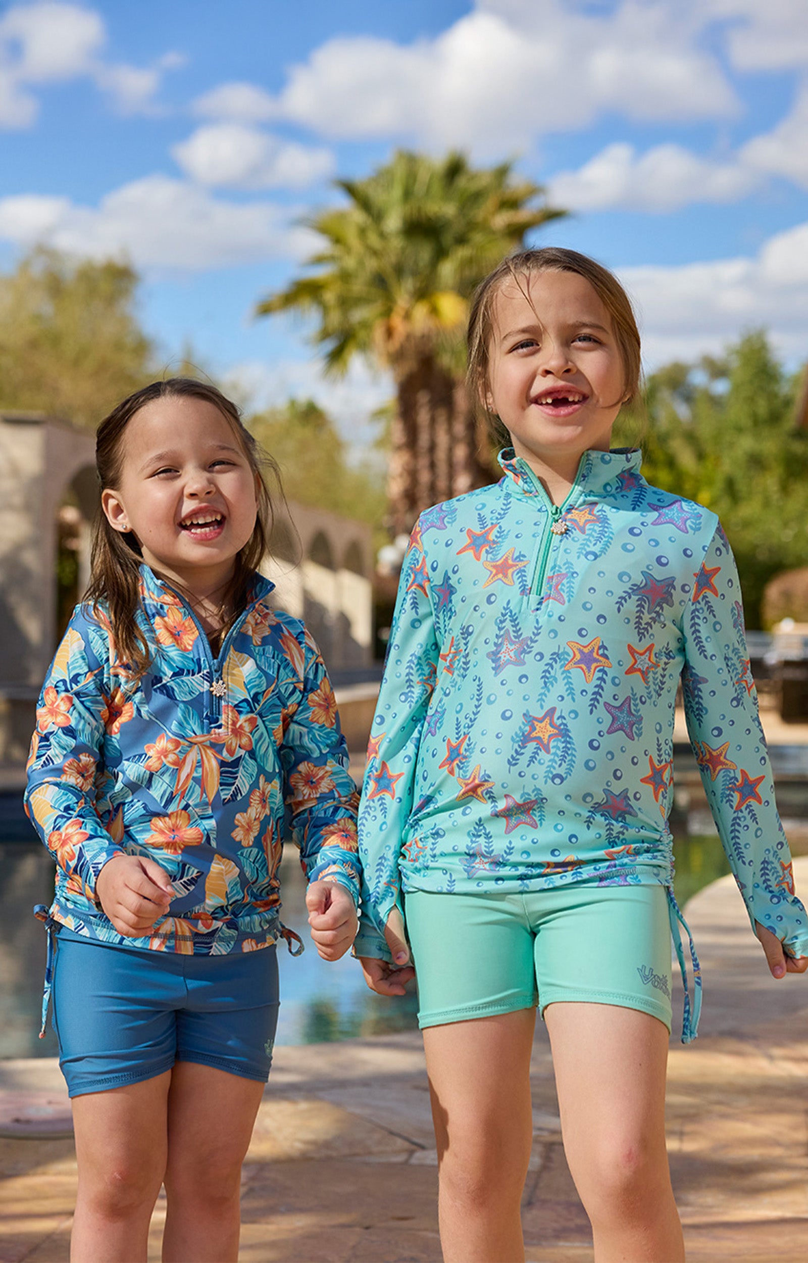 girls laughing in half zip ruched sun swim shirt poolside|maui-hibiscus