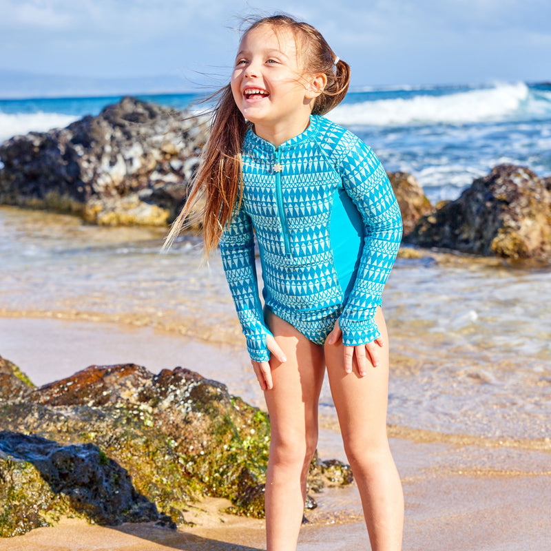 Young girl in UV Skinz's girl's long sleeve swimsuit in caribbean sparkle|caribbean-sparkle