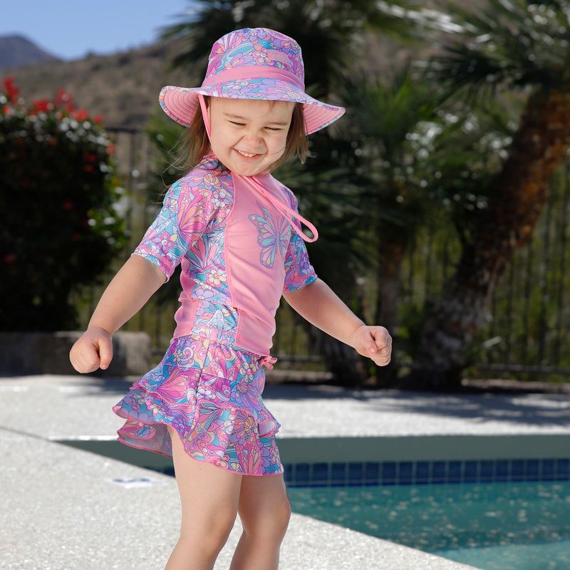 girl twirling by pool in swim hat|mosaic-butterflies