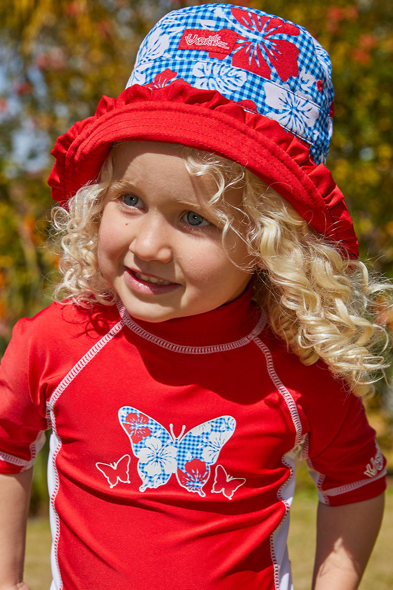 Little girl wearing UV Skinz's girls bucket hat in red americana gingham|red-americana-gingham