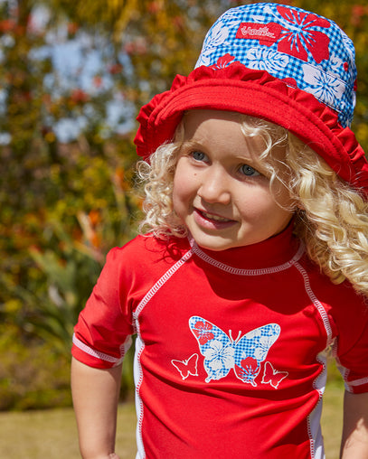 Little girl wearing UV Skinz's girls bucket hat in red americana gingham|red-americana-gingham