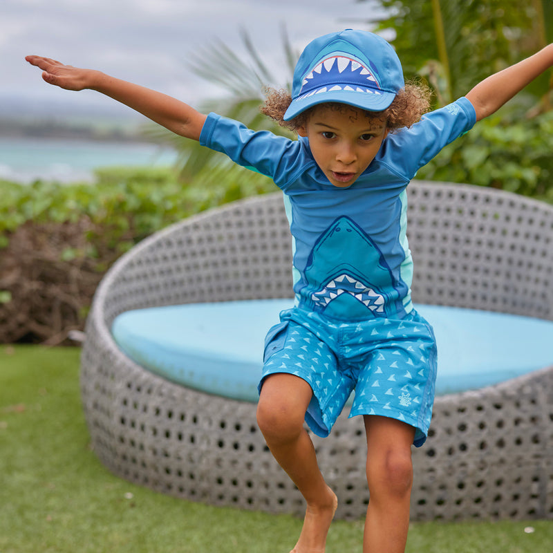 boy jumping in racer stripe board shorts|fin-tastic-adventure
