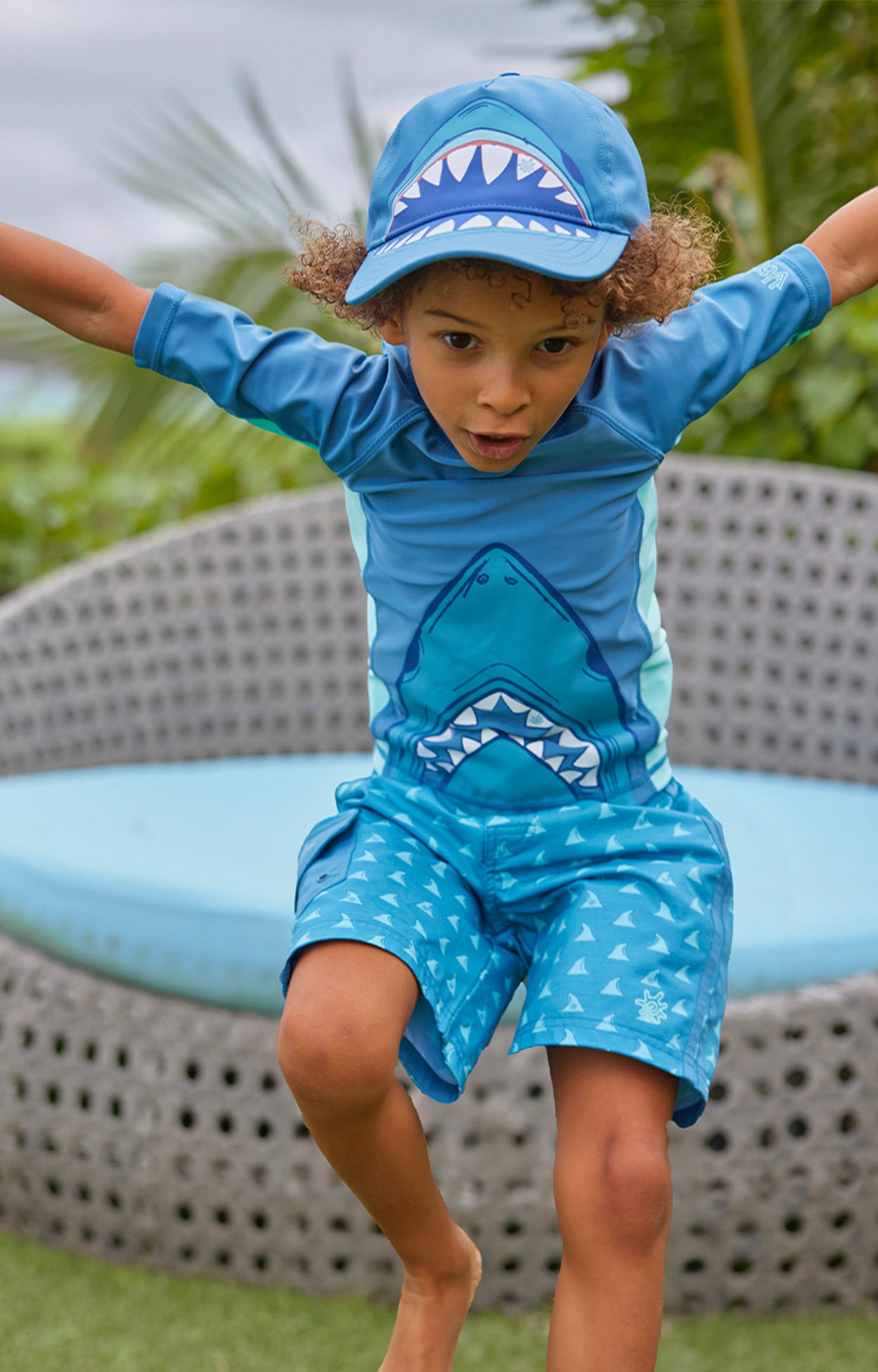boy jumping in racer stripe board shorts|fin-tastic-adventure