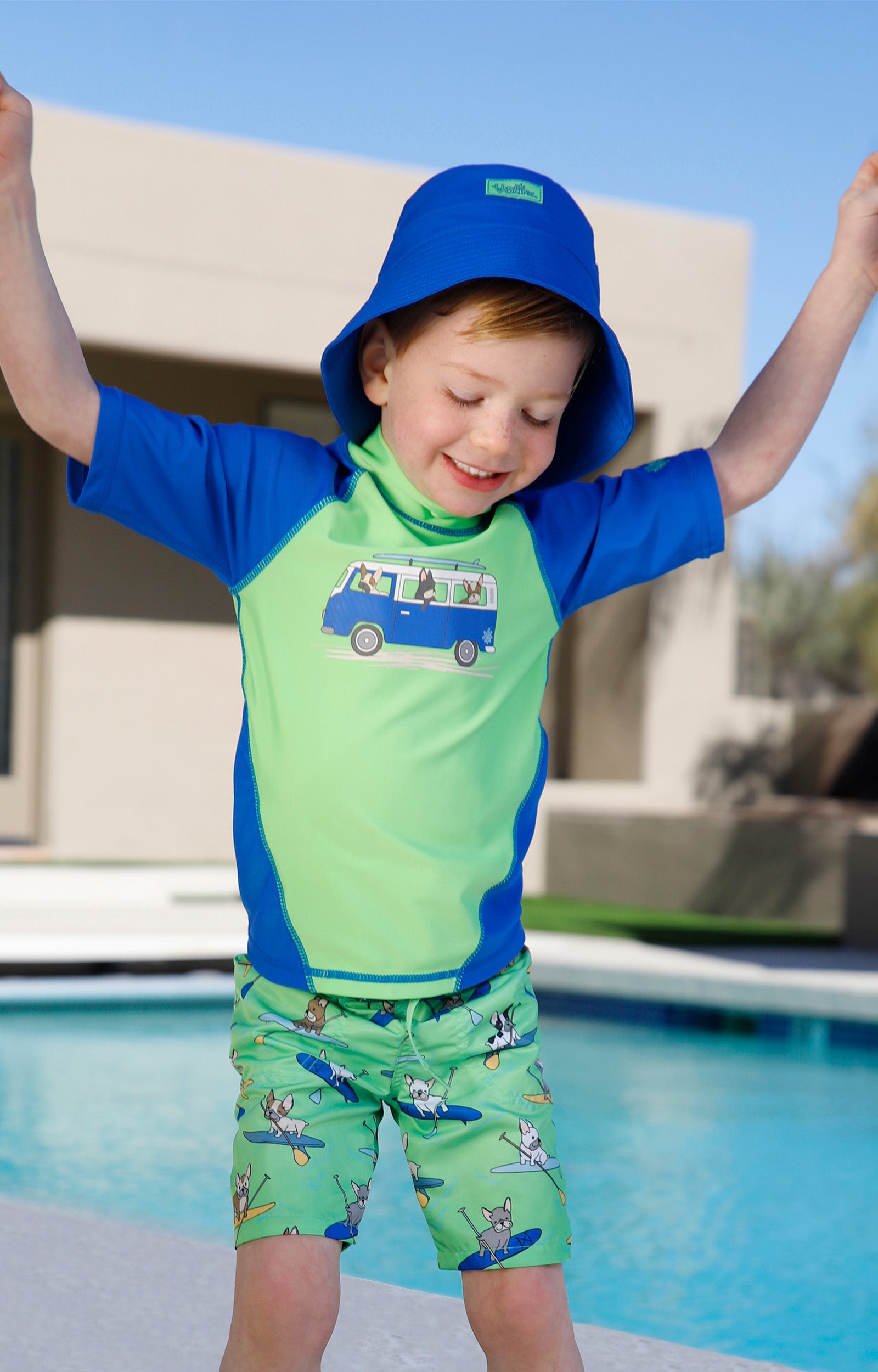 boy by the pool in magic beach shorts|magic-pups
