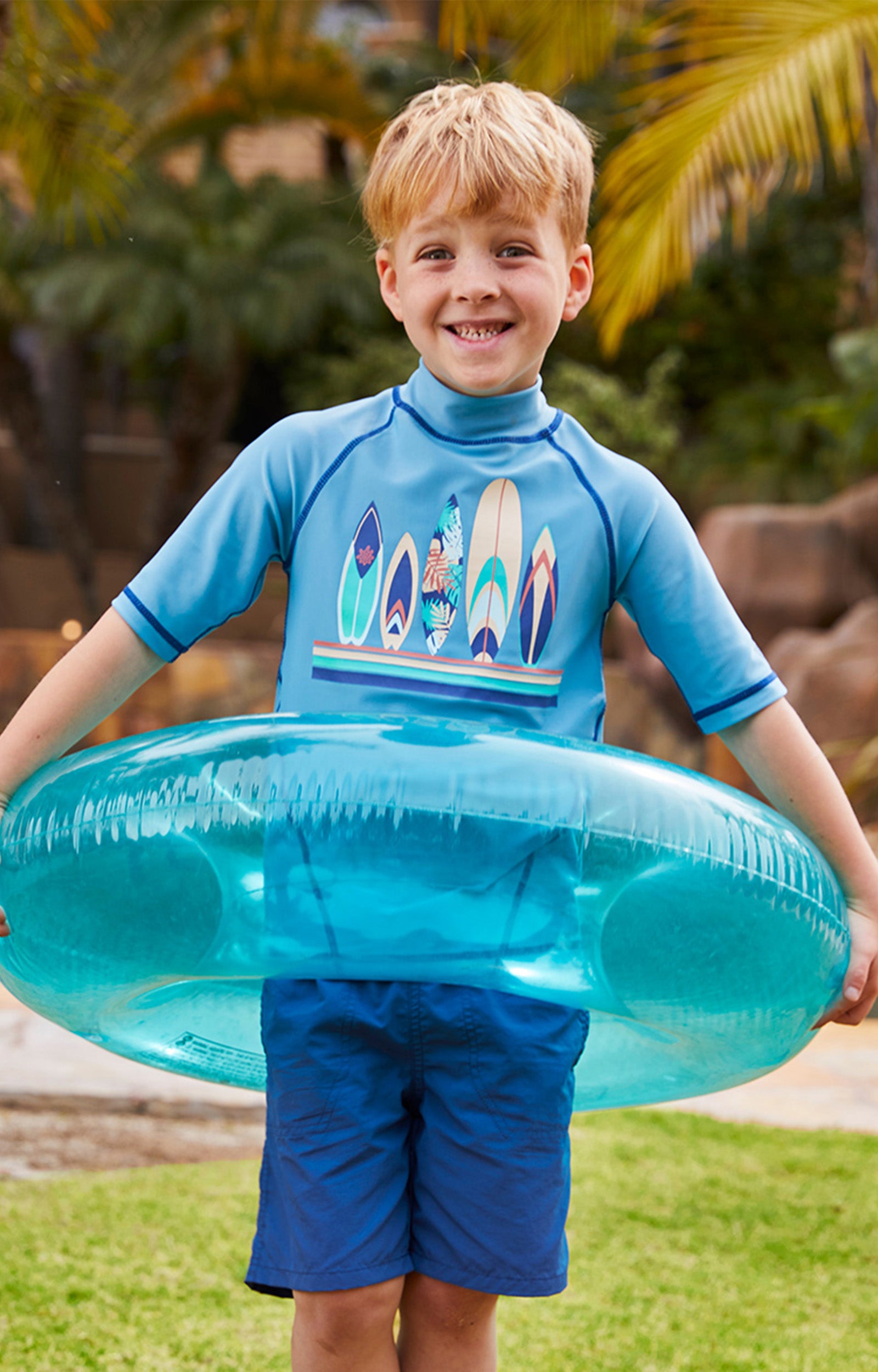 Boy in UV Skinz's boys beach shorts in washed navy|washed-navy