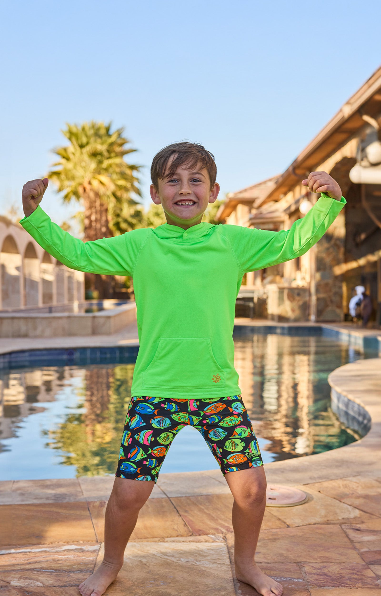boy by pool in pullover hoodie|neon-green