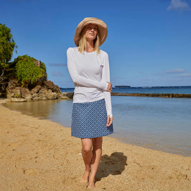 Woman Near the Water Wearing Her UV Skinz's Women's Travel Skort in Serenity Fish|serenity-fish