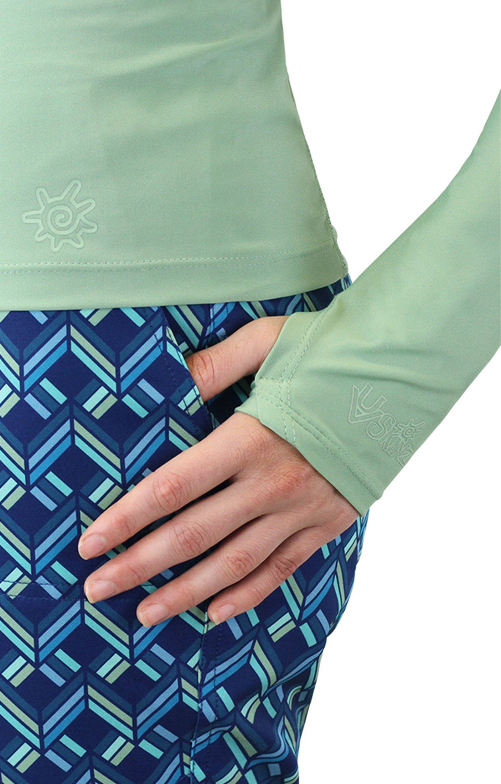 Close up of the thumb holes on the women's long sleeve rash guard in sage|sage