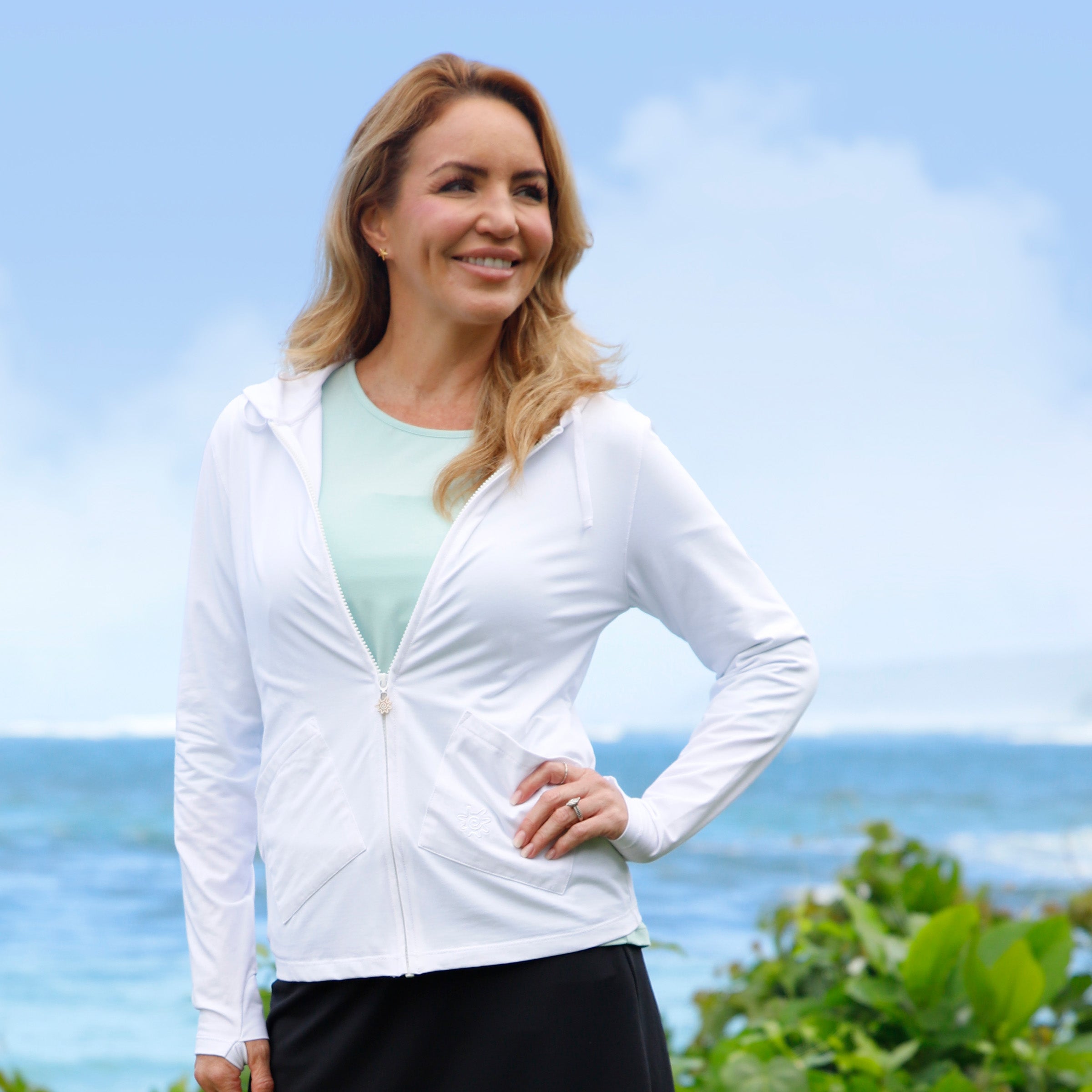 woman posing by the beach in women's hooded everyday jacket in white|white