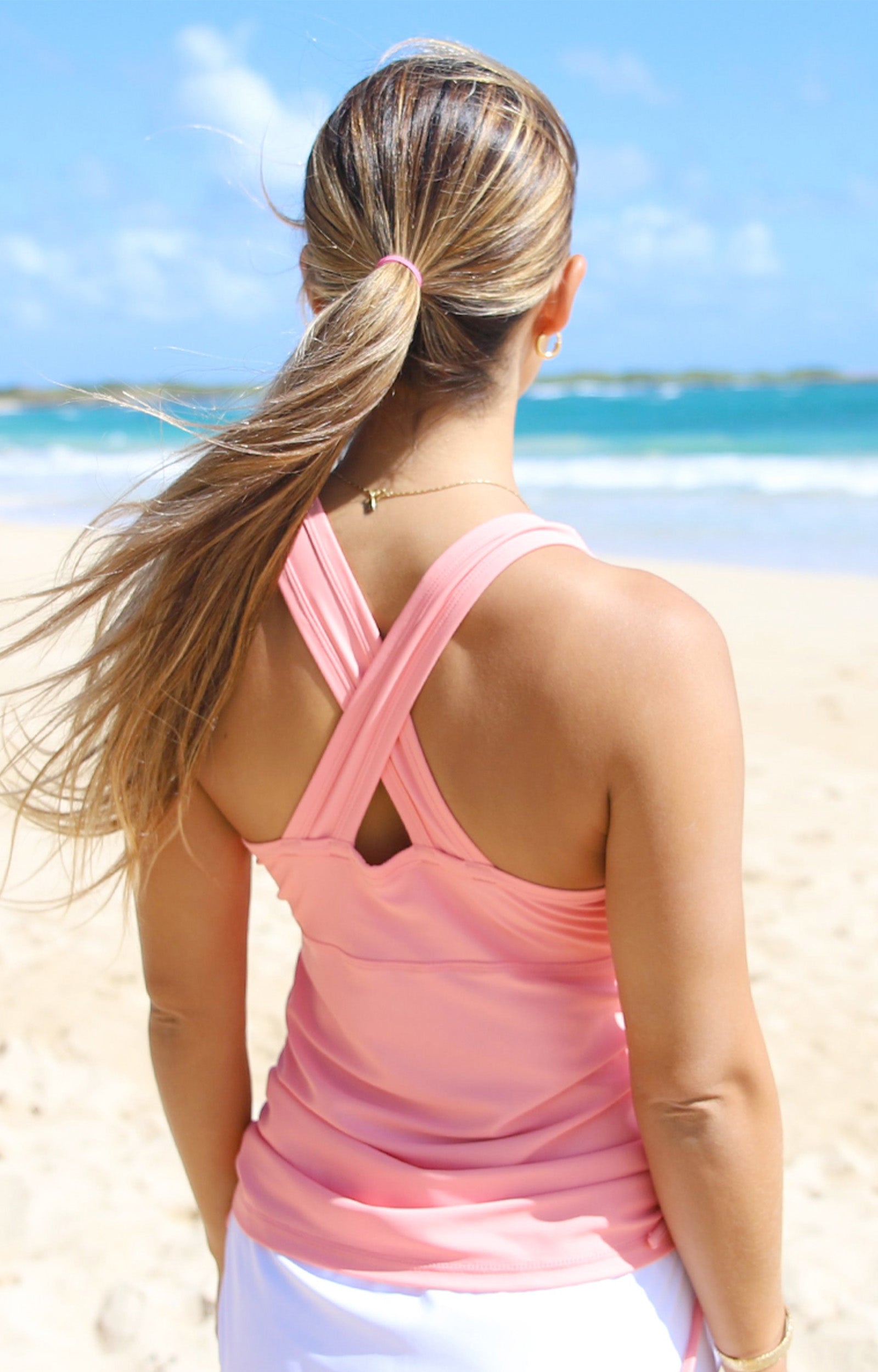 Woman on the beach in UV Skinz's women's ruched swim tank top|flamingo