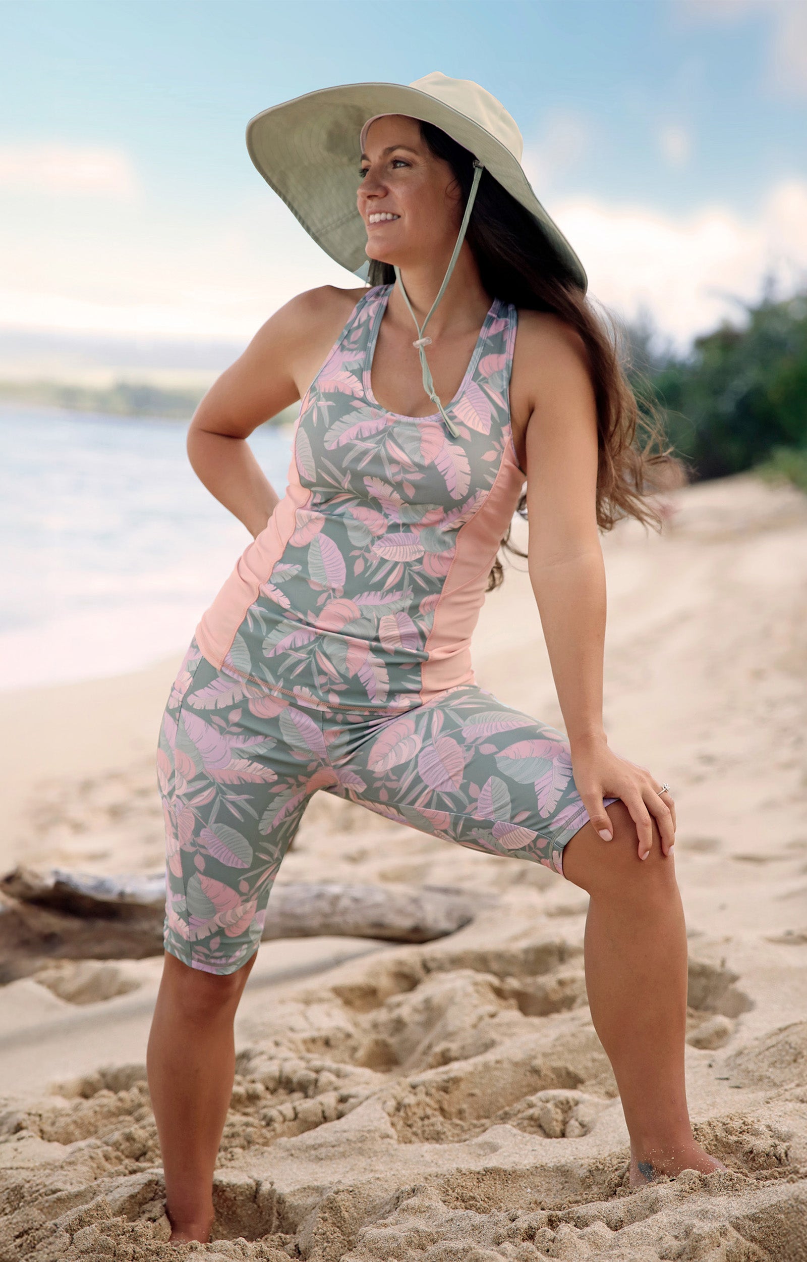 woman posing on the beach in racerback swim tank in lily pad leavescape|lily-pad-leavescape