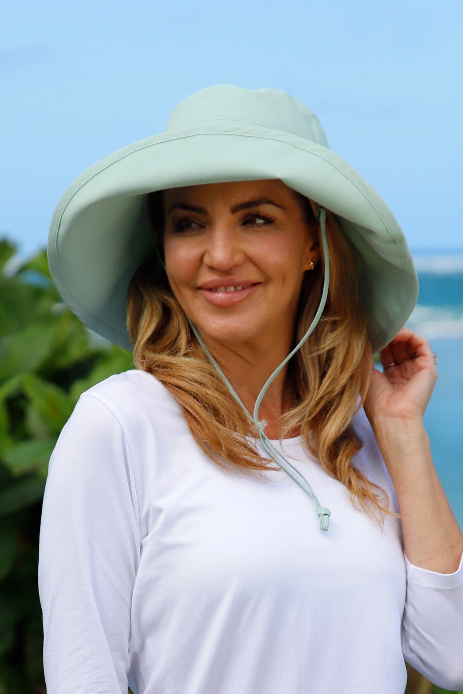 woman in women's roll up hat in dewdrop|dewdrop