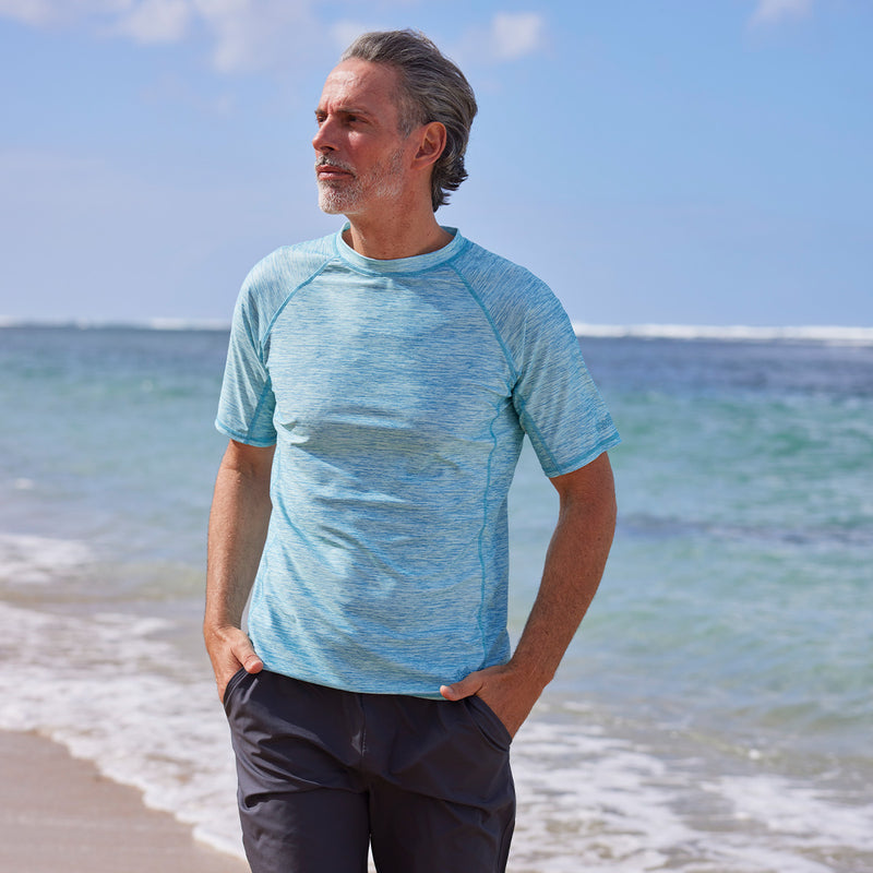 man walking on beach in short sleeve crew swim shirt|lagoon-jaspe