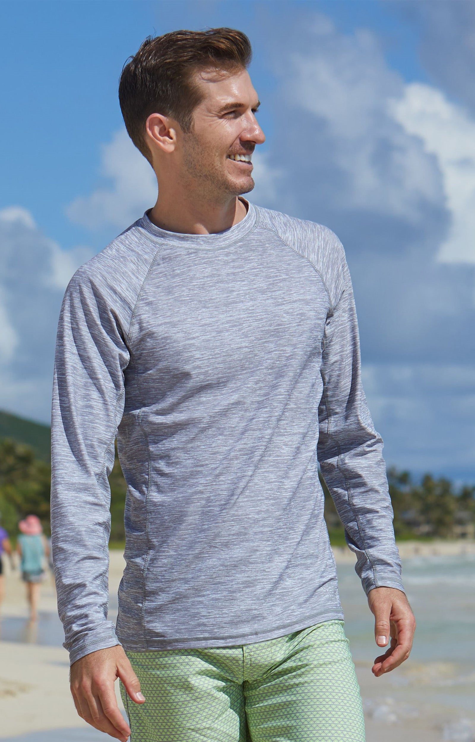 Man on the beach in UV Skinz's men's long sleeve crew swim shirt in cool grey jaspe|cool-grey-jaspe