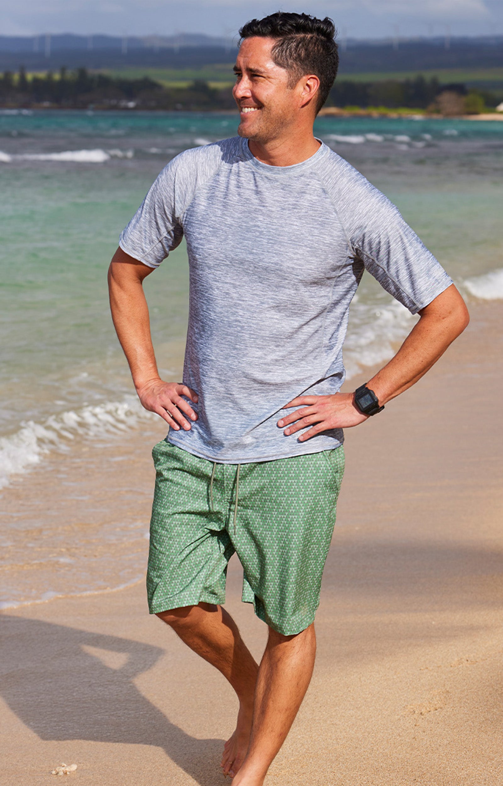 man walking on beach in waves in classic trunks|washed-olive-pyramid-geo