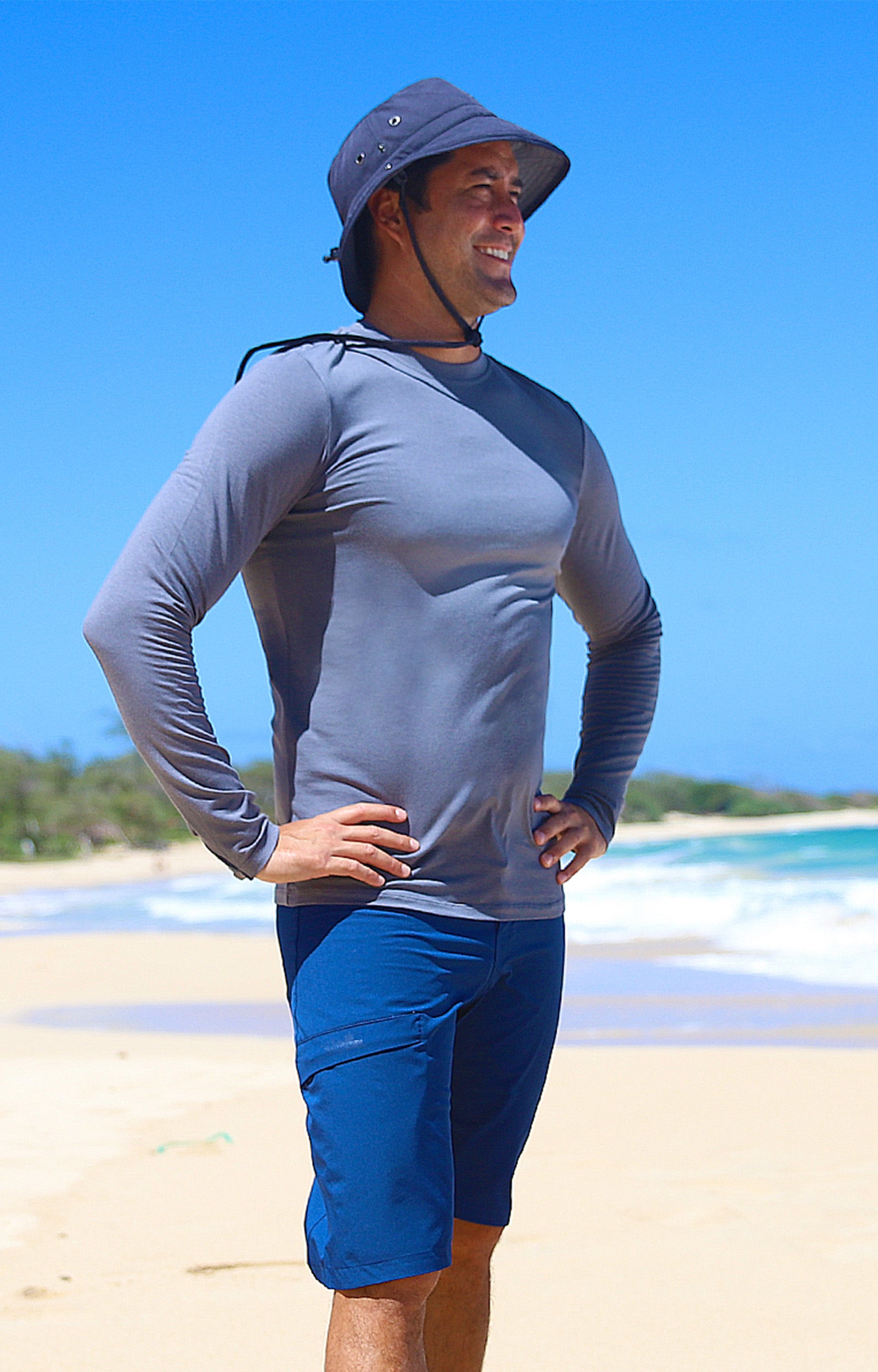 Man on the beach in UV Skinz's board shorts|dark-navy