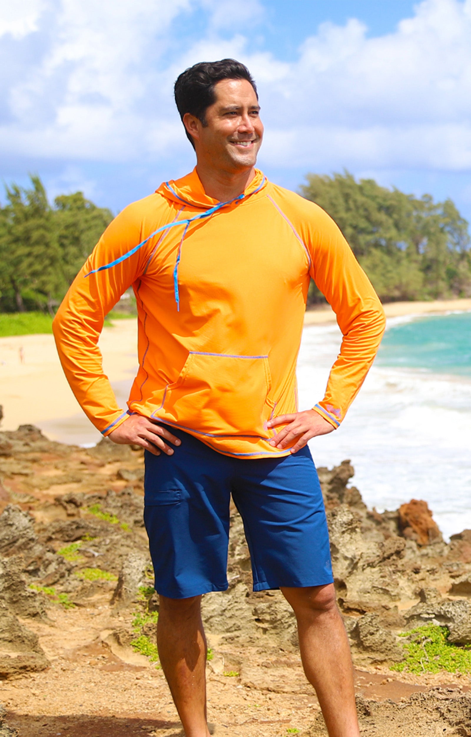 Man on the beach in UV Skinz's men's coastal board shorts in dark navy|dark-navy