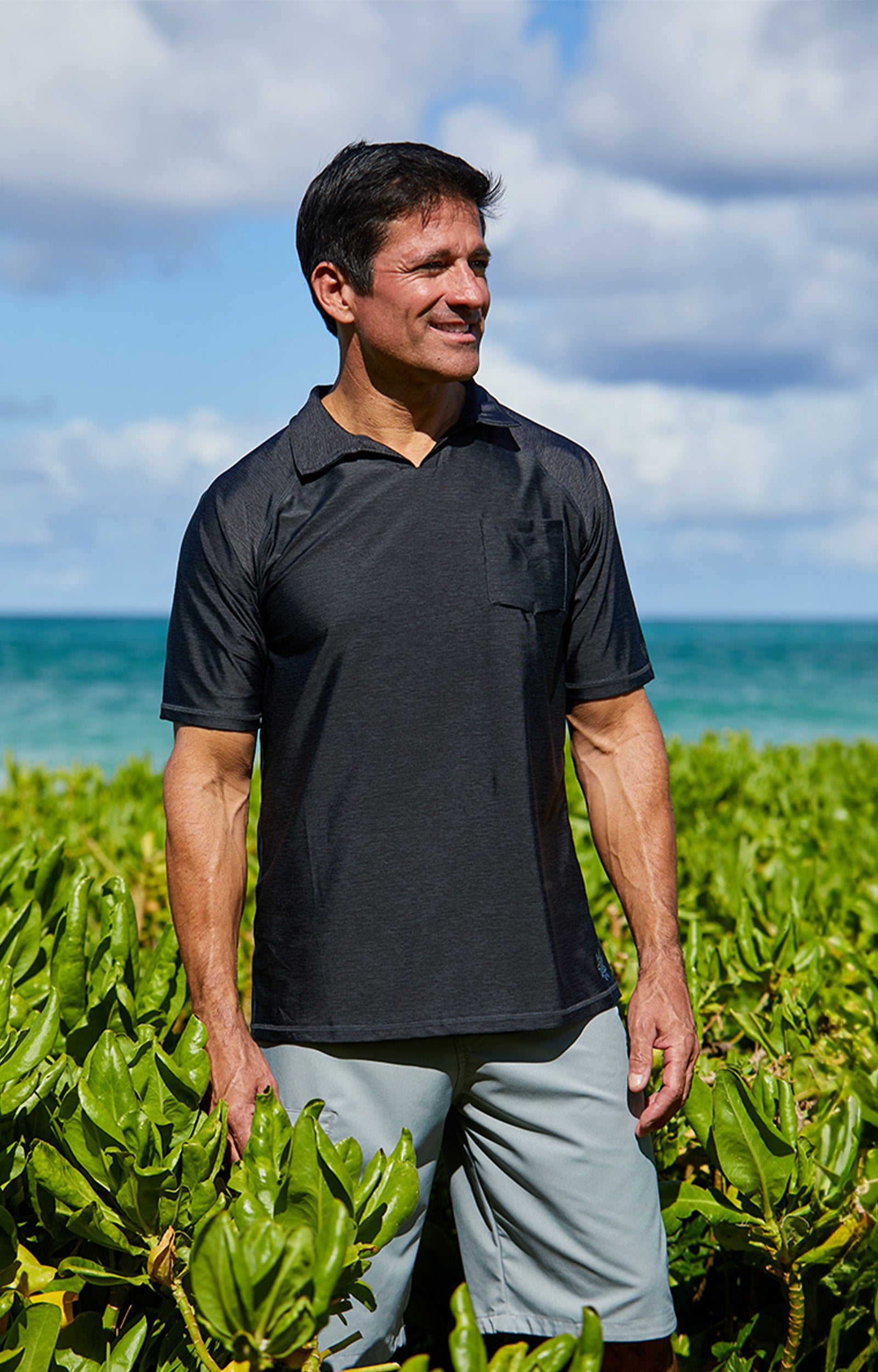 Man wearing UV Skinz's men's coastal board shorts in grey on the beach|grey