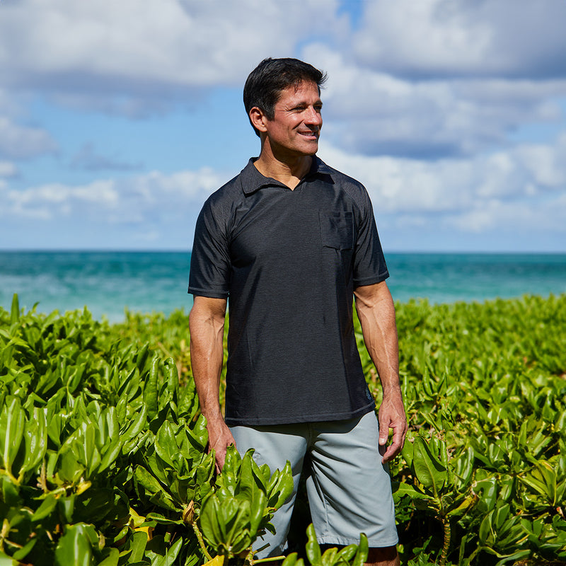 Man wearing UV Skinz's men's coastal board shorts in grey on the beach|grey