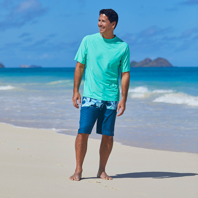 Man wearing UV Skinz's men's coastal board shorts in midnight hawaiian stripe|midnight-hawaiian-stripe