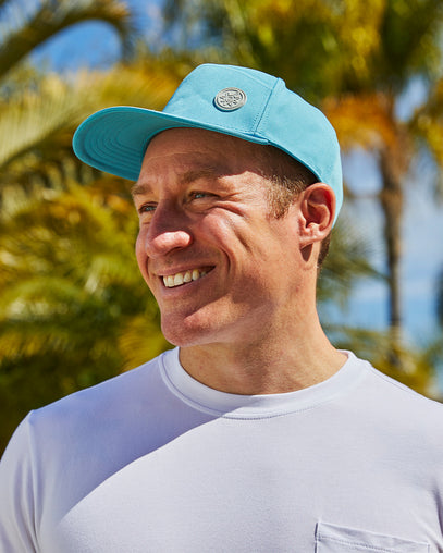 Man in UV Skinz's men's snapback hat in lagoon|lagoon