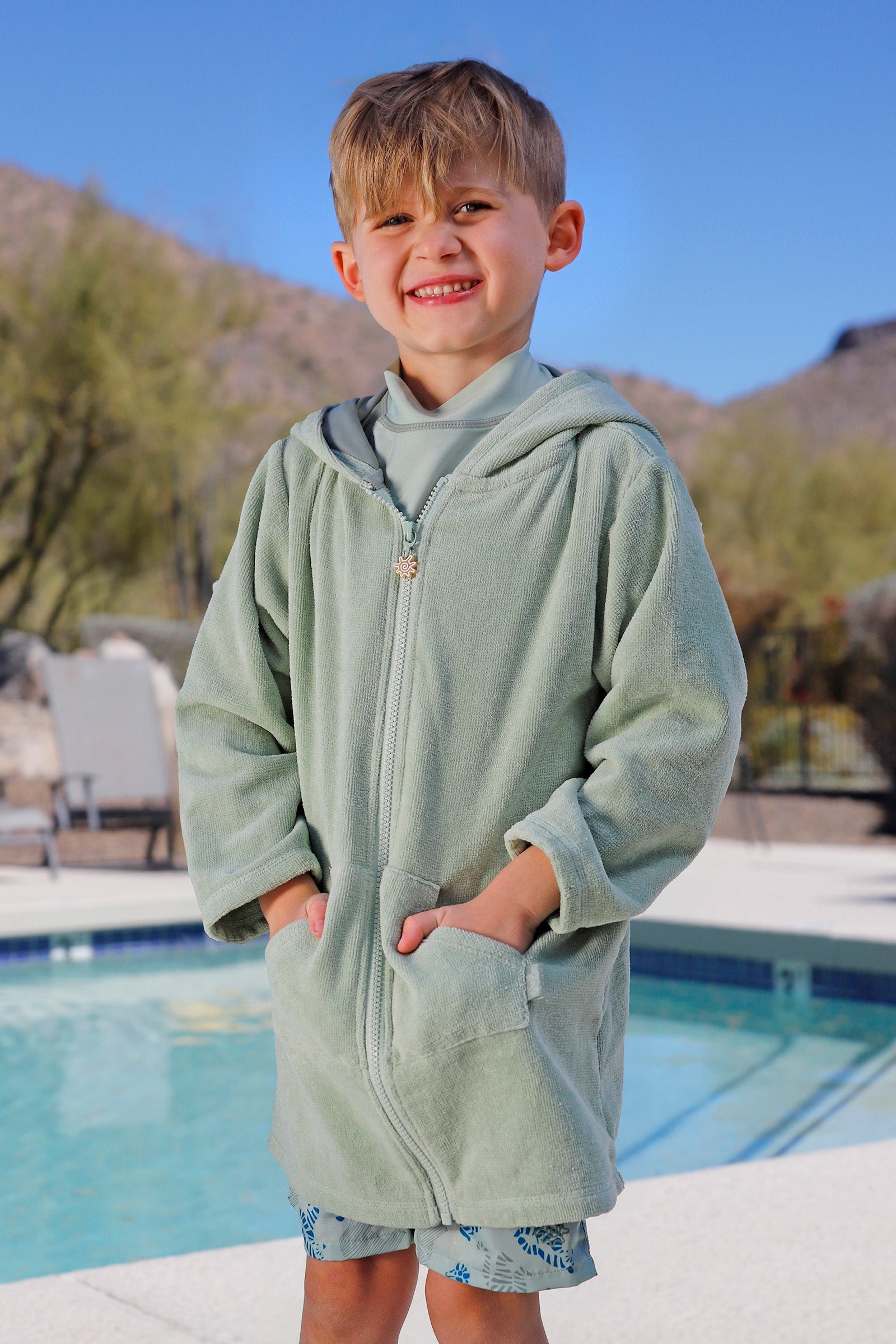 boy by pool in kids hooded terry beach cover up|frosty-green
