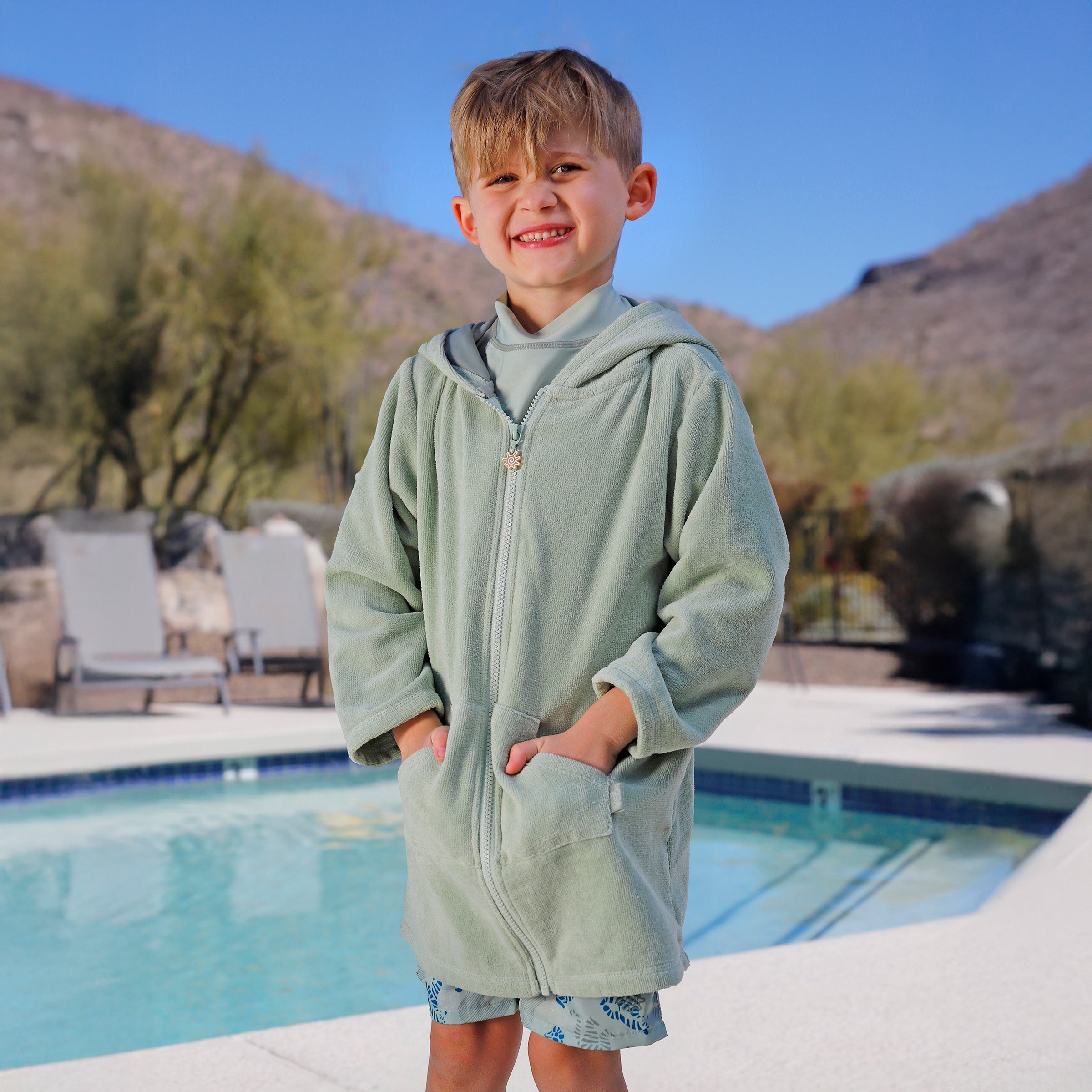 boy by pool in kids hooded terry beach cover up|frosty-green