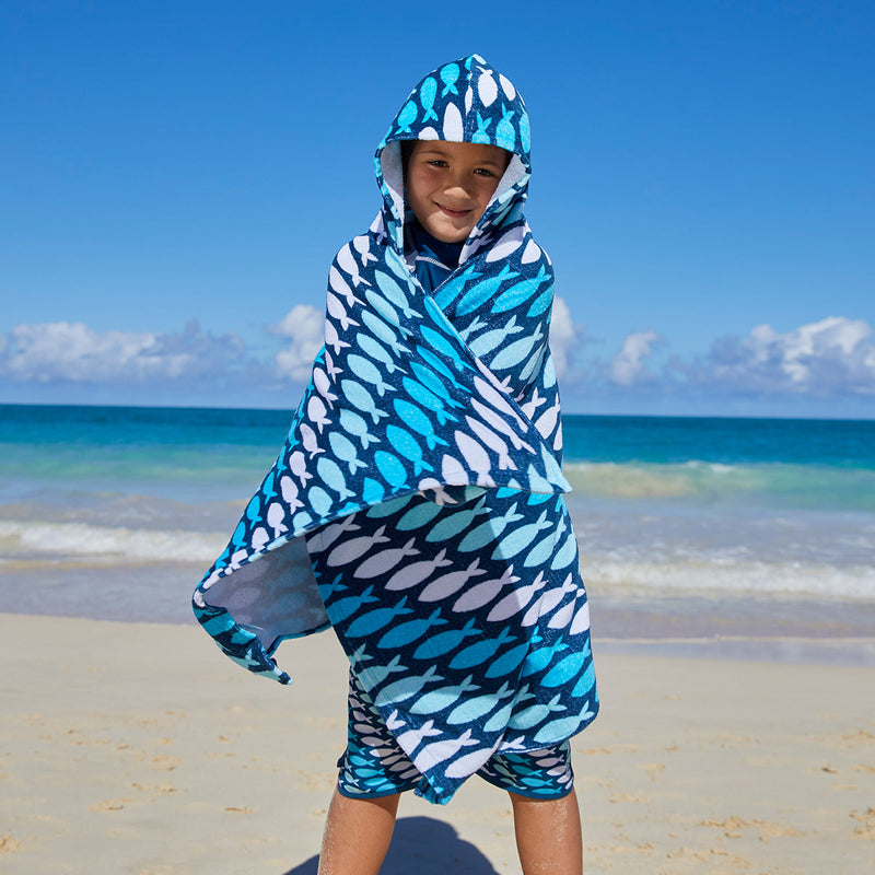 Kid in UV Skinz's kid's hooded beach towel in fish trailz|fish-trailz