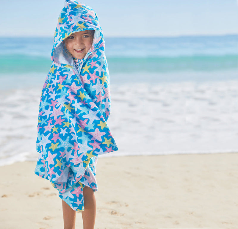Kid in UV Skinz's kid's hooded beach towel in starfish party|starfish-party