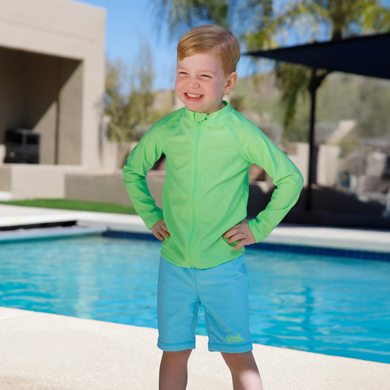 boy playing by pool wearing kids neon swim and play jammerz|neon-sky