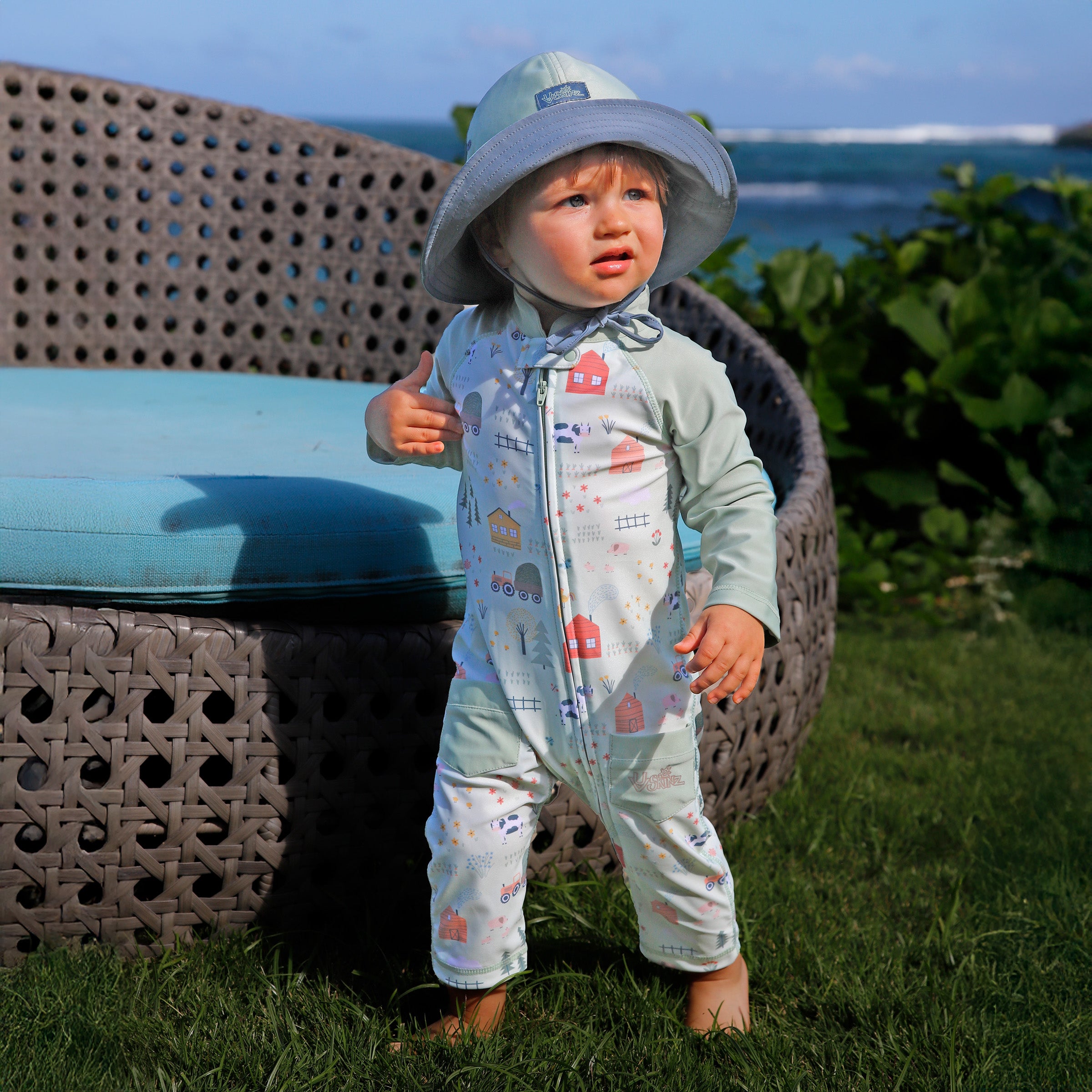 baby boy in grass in on the farm|on-the-farm