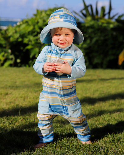 baby boy in grass in reversible sun hat in pinecrest stripe|pinecrest-stripe