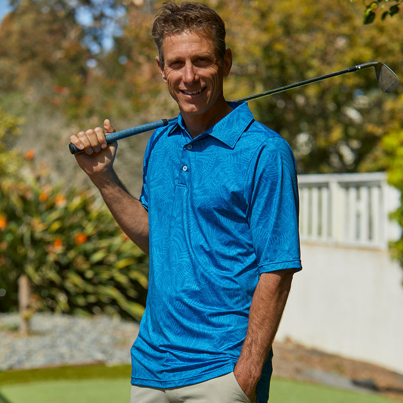 Man golfing in UV Skinz's men's short sleeve polo in distressed belize tropics|belize-tropics