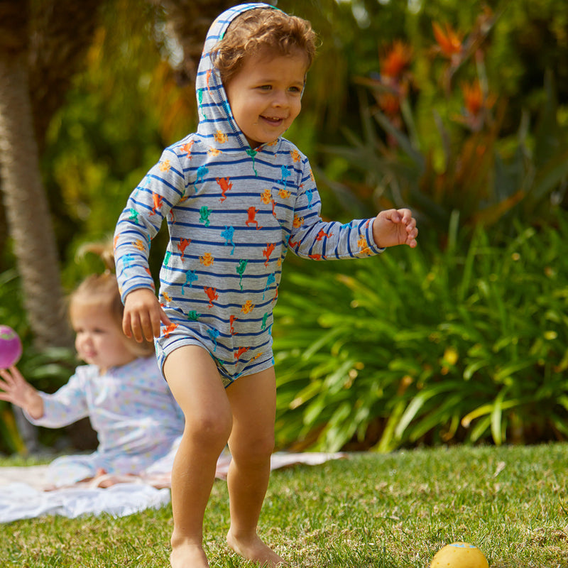 Young Boy Playing with a Ball in the Baby Boy's Hooded Sunzie in Hang Ten Dinos|hang-ten-dinos