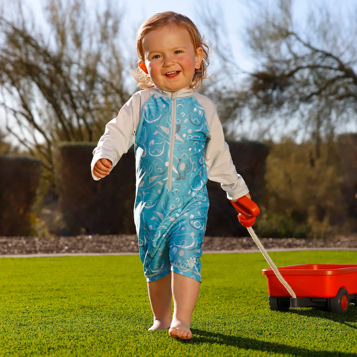 Baby in UV Skinz swimwear for first water experiences