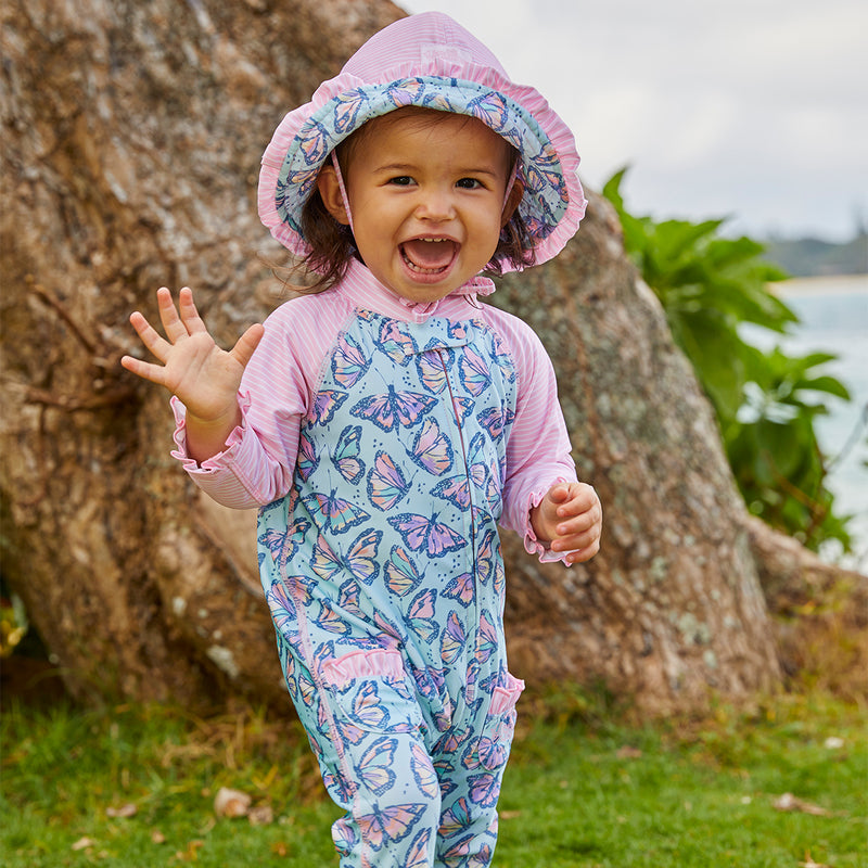 Little baby girl in UV Skinz's baby girls long-sleeve swimsuit in sweet butterflies|sweet-butterflies