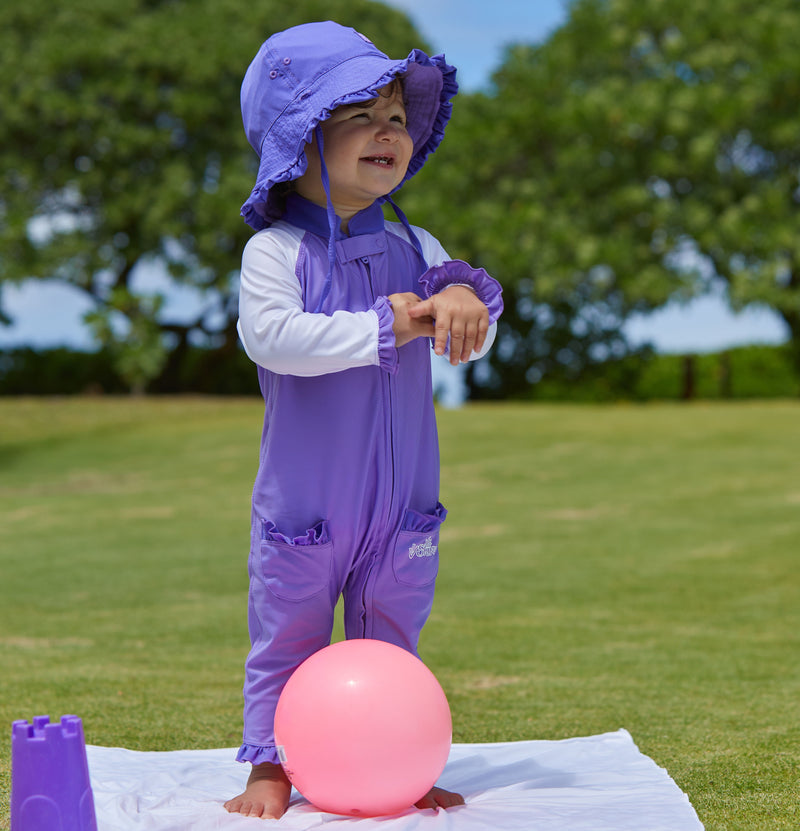 little baby girl in UV Skinz's baby girls long-sleeve swimsuit in misty purple white|misty-purple-white