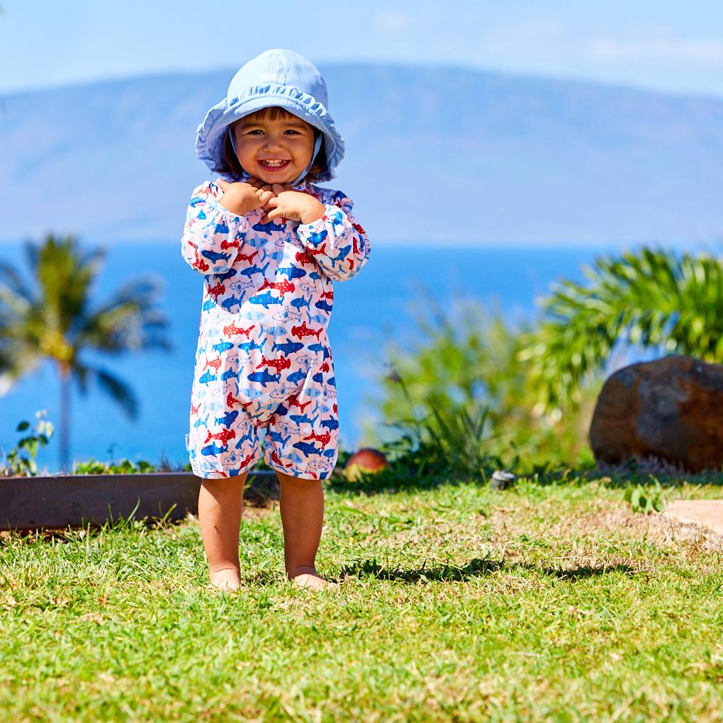 Little girl in the baby girl's one-piece swimsuit in americana girly sharks|americana-girly-sharks