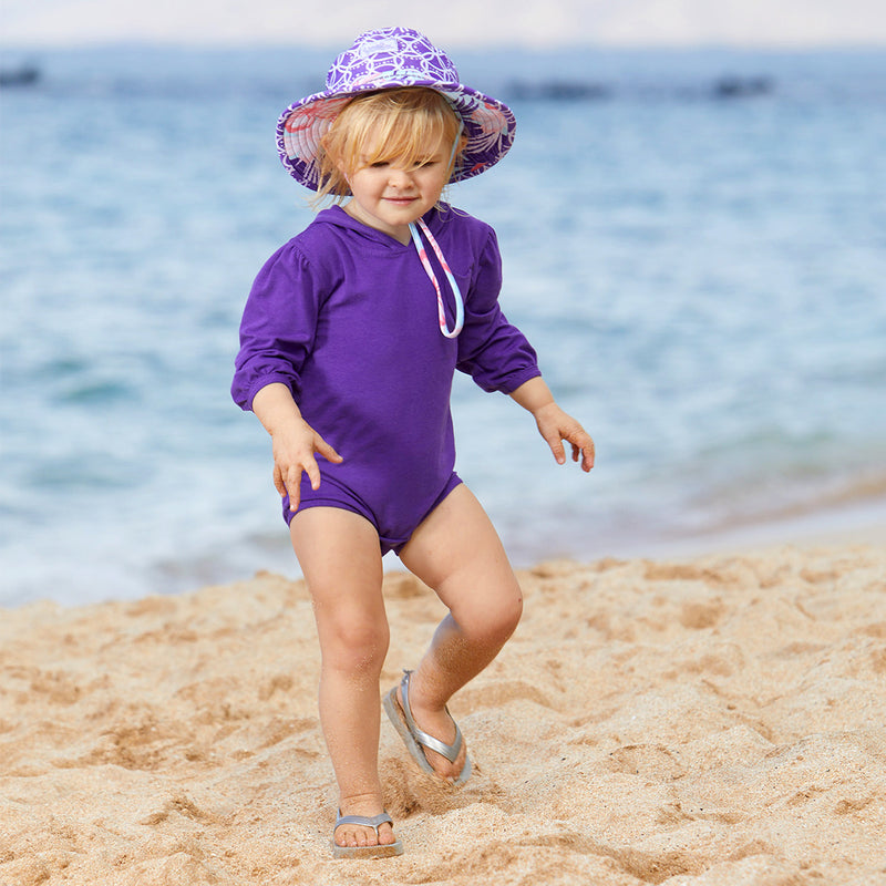 Baby Girl on the Beach in the Baby Girl's Hooded Sunzie in Orchid|orchid