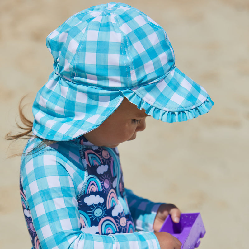 Baby girl in UV Skinz's baby girls swim flap hat in good day gingham|good-day-gingham