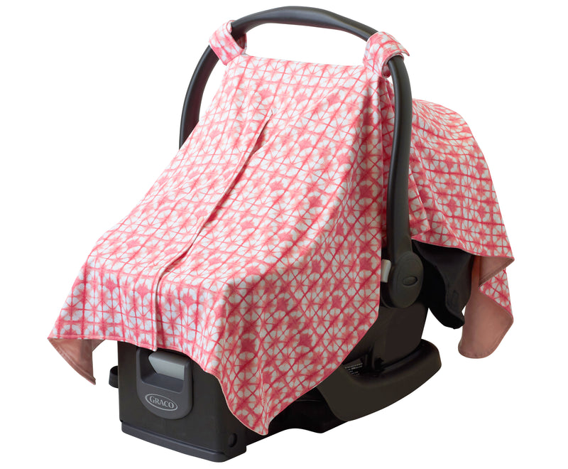 Sun protective car seat cover for babies in tie dyed pinks over a car seat|tie-dyed-pinks