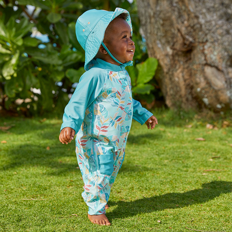 baby boy in the baby boy's long-sleeve swimsuit in tropical cascade|tropical-cascade
