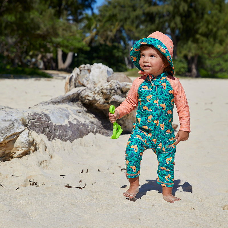Baby boy on the beach wearing UV Skinz's baby boy's long-sleeve swimsuit in cool chameleons|cool-chameleons