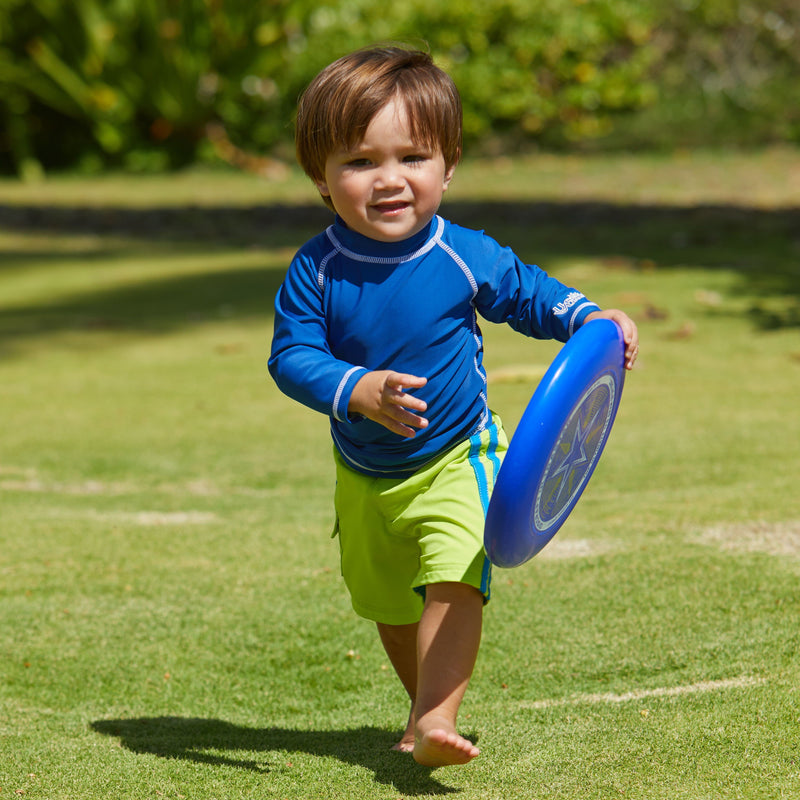 Little boy playing frisbee in UV Skinz's baby long sleeve swim shirt in navy|navy
