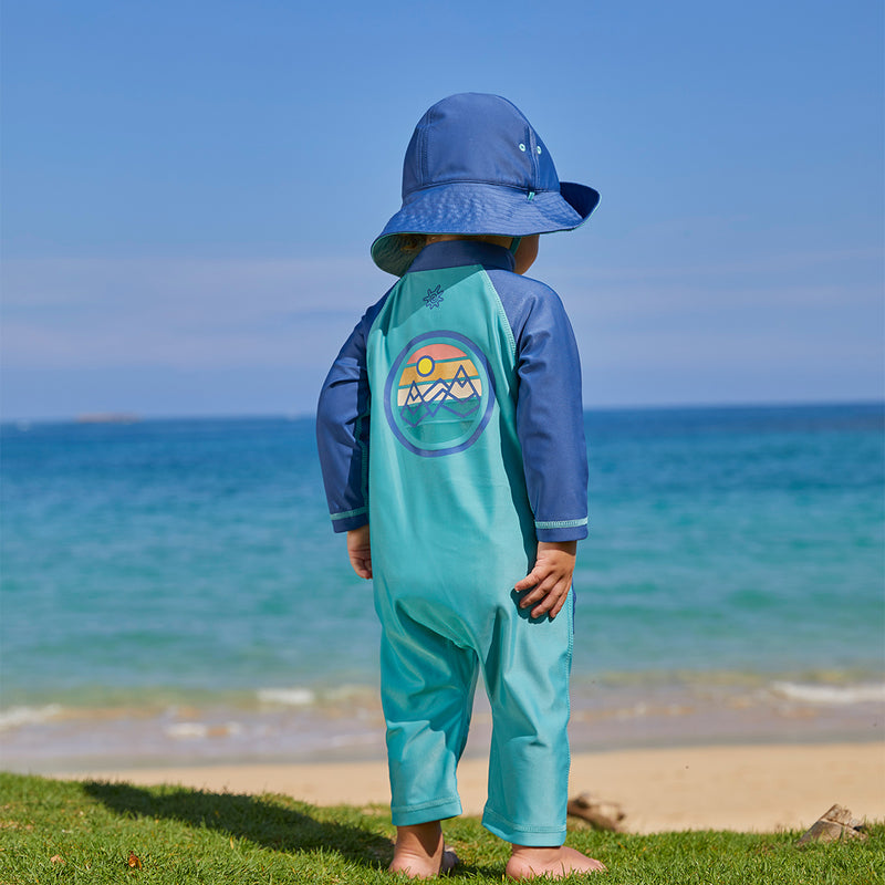 Baby boy on the beach in UV Skinz's baby boy's long-sleeve swimsuit in endless summer|endless-summer