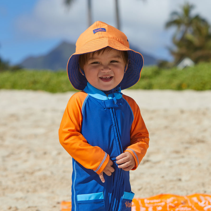 Little boy in UV Skinz's baby boy's sun hat in navy blue orange|navy-blue-orange